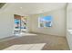 Bright basement with neutral carpeting, large window and sliding glass door to patio at 694 Penn Rd, Elizabeth, CO 80107