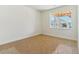 Bright bedroom with neutral carpeting and a window overlooking the backyard at 694 Penn Rd, Elizabeth, CO 80107