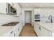 Modern kitchen with white cabinets, quartz countertops, and stainless steel appliances at 694 Penn Rd, Elizabeth, CO 80107