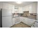 White kitchen with granite countertops, featuring a microwave, oven, and dishwasher at 3465 S Poplar St # 308, Denver, CO 80224