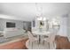 Bright dining area with a round table, chairs, and an open concept to the living room at 3465 S Poplar St # 308, Denver, CO 80224
