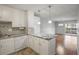 Kitchen with granite countertops, white cabinets, and an island at 3465 S Poplar St # 308, Denver, CO 80224