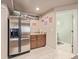 Basement wet bar with refrigerator and cabinets at 11533 Dahlia St, Thornton, CO 80233