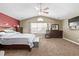 Large main bedroom with carpeted floors, ceiling fan, and ensuite bathroom at 11533 Dahlia St, Thornton, CO 80233