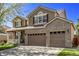 Two-story house with brown siding, brick accents, and a two-car garage at 11533 Dahlia St, Thornton, CO 80233