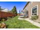 Backyard with a trampoline, patio, and landscaped flowerbeds at 11533 Dahlia St, Thornton, CO 80233