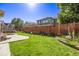 Landscaped backyard with a wooden fence and grassy area at 11533 Dahlia St, Thornton, CO 80233