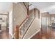 Elegant staircase with wood railings connecting the main and upper levels at 11533 Dahlia St, Thornton, CO 80233