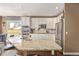 Modern kitchen with granite island, stainless steel appliances, and ample counter space at 11533 Dahlia St, Thornton, CO 80233