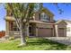 Two-story house with brown siding, brick accents, and a large front yard at 11533 Dahlia St, Thornton, CO 80233