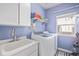 Laundry room with washer, dryer, and utility sink at 11533 Dahlia St, Thornton, CO 80233