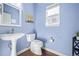 Clean and updated half bathroom with pedestal sink at 11533 Dahlia St, Thornton, CO 80233