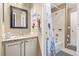 Bathroom with granite countertop, white cabinets, and a bathtub at 11533 Dahlia St, Thornton, CO 80233