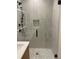 Modern bathroom with a glass shower and marble tile at 1254 Yates St, Denver, CO 80204