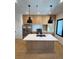 Modern kitchen with light wood cabinets and island at 1254 Yates St, Denver, CO 80204