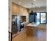 Modern kitchen with light wood cabinets and island at 1254 Yates St, Denver, CO 80204