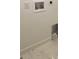 Bright laundry room with built-in shelving and hookups at 1254 Yates St, Denver, CO 80204