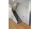 Modern staircase with metal railing and light wood floors at 1254 Yates St, Denver, CO 80204