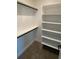 Spacious walk-in closet with shelves and hanging rods at 1254 Yates St, Denver, CO 80204