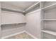 Spacious walk-in closet with shelves and hanging rods at 7262 Xenophon Ct, Arvada, CO 80005