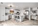 Modern kitchen with white cabinets, stainless steel appliances, and a kitchen island at 7652 Pennsylvania Ct, Denver, CO 80229