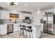 Modern kitchen with white cabinets, stainless steel appliances, and a kitchen island at 7652 Pennsylvania Ct, Denver, CO 80229