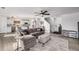 Open-concept living room showcasing a sectional sofa and a view into the kitchen at 7652 Pennsylvania Ct, Denver, CO 80229