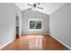 Bright bedroom with wood floors, ceiling fan, and window overlooking backyard at 19058 E Bonney Ct, Parker, CO 80134