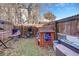 Fenced backyard with playhouse and hammock at 1735 E 35Th Ave, Denver, CO 80205