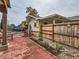 Brick patio, wooden fence, landscaping, and covered patio at 2605 W Cornell Ave, Denver, CO 80236