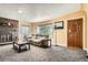 Living room with stone fireplace and large windows at 2605 W Cornell Ave, Denver, CO 80236