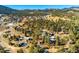 Expansive aerial view showcasing the neighborhood and mountains at 29116 Pine Rd, Evergreen, CO 80439