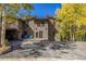 Two story home with a large driveway and autumn trees at 537 Moonstone Rd, Breckenridge, CO 80424