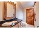 Bathroom features a rustic wood vanity and large mirror at 537 Moonstone Rd, Breckenridge, CO 80424