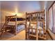 Rustic bunk beds in a spacious bedroom with large windows at 537 Moonstone Rd, Breckenridge, CO 80424