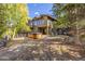 Deck with a hot tub and a view of the surrounding forest at 537 Moonstone Rd, Breckenridge, CO 80424