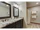 Double vanity bathroom with granite countertops and shower/tub combo at 537 Moonstone Rd, Breckenridge, CO 80424