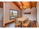 Rustic dining room with wood table and mountain views at 537 Moonstone Rd, Breckenridge, CO 80424