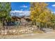 House exterior showcasing landscaping and a stone retaining wall at 537 Moonstone Rd, Breckenridge, CO 80424