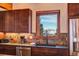 Kitchen features mountain views and dark wood cabinets at 537 Moonstone Rd, Breckenridge, CO 80424