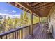 Wooden deck with mountain views and wooden chairs at 537 Moonstone Rd, Breckenridge, CO 80424