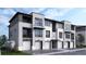 Modern three-story townhome building with attached garages and landscaping at 11930 Soprano Cir # 203, Lone Tree, CO 80134