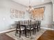 Dining room featuring hardwood floors, a large table, and unique wall art at 22980 E Del Norte Cir, Aurora, CO 80016