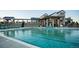 Community pool with lounge chairs and clubhouse in background at 8844 Whiteclover St, Littleton, CO 80125