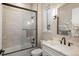 Modern bathroom with white vanity, glass shower, and stylish fixtures at 11229 Running Kit Pl, Franktown, CO 80116