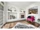 Living room with fireplace and built-in shelving, hardwood floors and view to kitchen at 466 Black Feather Loop # 510, Castle Rock, CO 80104