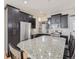 Spacious kitchen with granite countertops and dark cabinetry at 2514 Sweet Wind Ave, Castle Rock, CO 80109