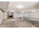 Spacious finished basement with fireplace and neutral carpeting at 5001 E Iliff Ave, Denver, CO 80222