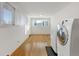 Laundry room with washer, dryer, and hardwood floors at 5001 E Iliff Ave, Denver, CO 80222