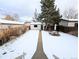 Snowy backyard with detached garage and patio at 2180 S Logan St, Denver, CO 80210